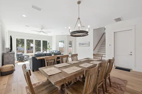 a view of a dining room with furniture wooden floor and chandelier