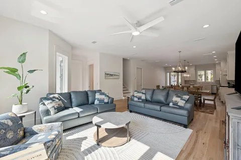 a living room with furniture and a large mirror