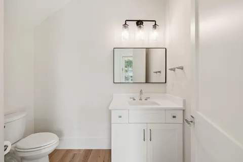 a bedroom with a large bed and a flat tv screen on dresser