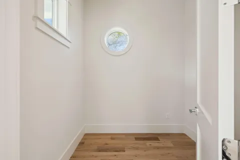 a bedroom with a bed and a flat screen tv in white walls