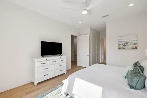 a bedroom with a large bed and a tv