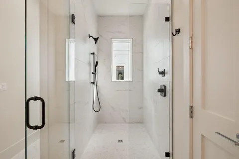 a bathroom with a toilet a sink a mirror a bathtub and vanity