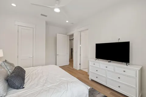 a bathroom with a bathtub shower sink vanity and toilet