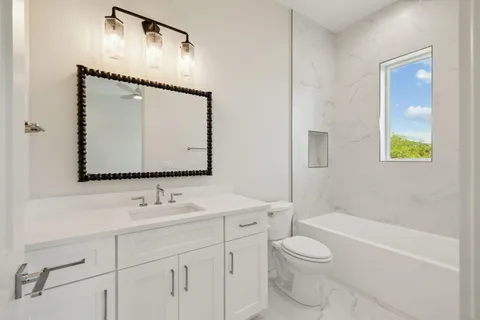 a bedroom with a large bed and a night stand