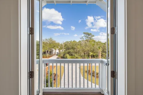 a view of cabinets a sink and a stove in a kitchen