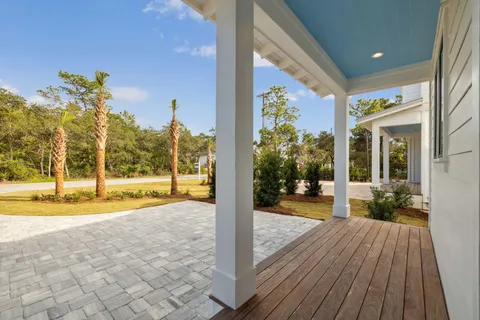 a view of a house with a swimming pool and sitting area