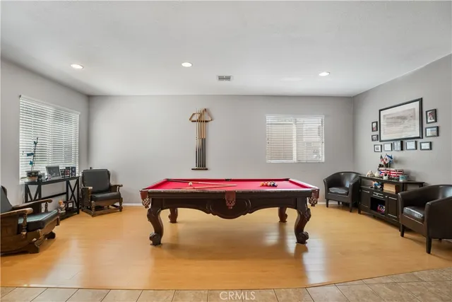a room with furniture pool table and windows