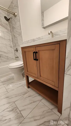 a bathroom with a sink a mirror and shower