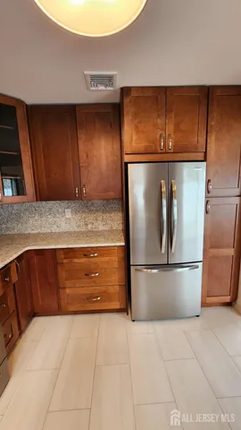 a kitchen with a refrigerator and microwave