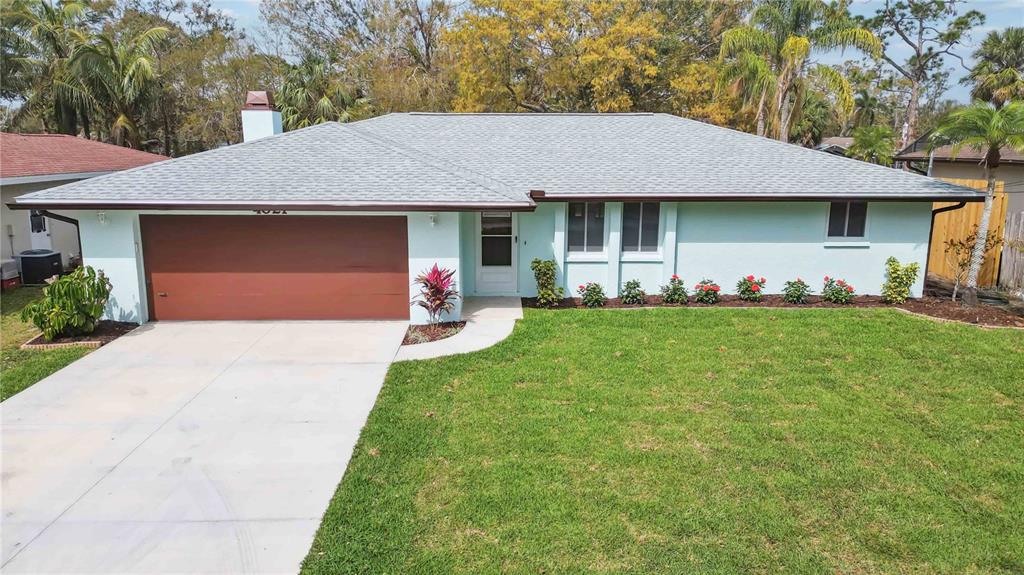 4021 Barry Way Sarasota, FL 34232 - Photo 1 of 1 a front view of a house with a yard and garage
