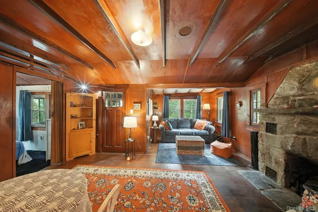 a living room with furniture a fireplace and a large window