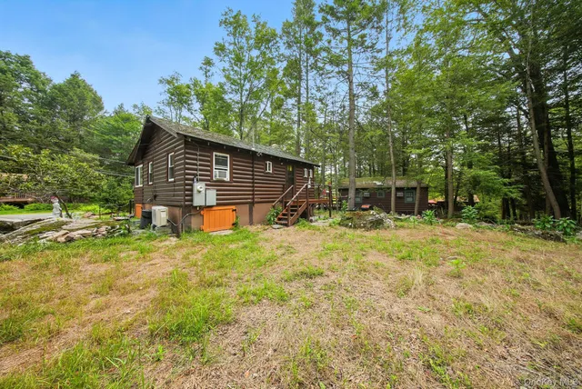 a backyard of a house with table and chairs