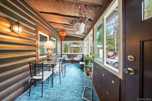 a view of a dining room with furniture large windows and wooden floor