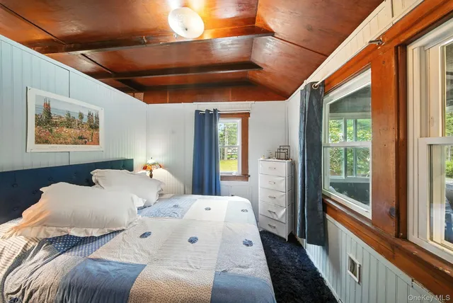 a bedroom with a large bed and a large window