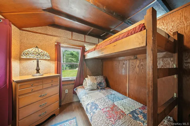 a bed room with a bed and a dresser