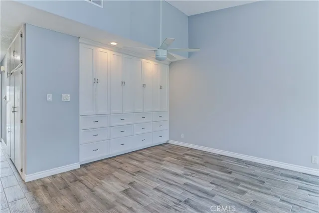 a kitchen with granite countertop white cabinets and stainless steel appliances
