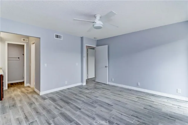 a view of walk in closet with empty racks