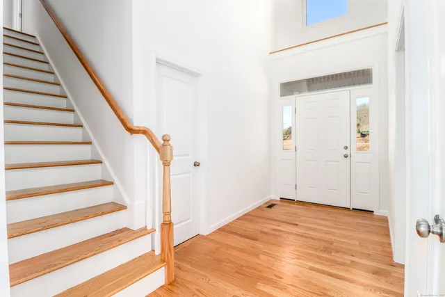 a large kitchen with stainless steel appliances a stove a refrigerator a oven and a sink with cabinets