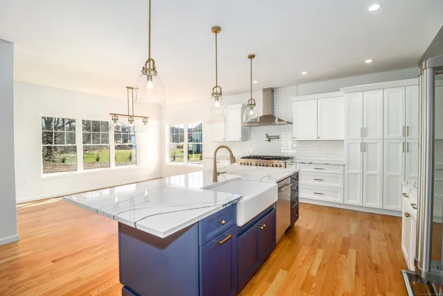a bathroom with a granite countertop sink and a toilet