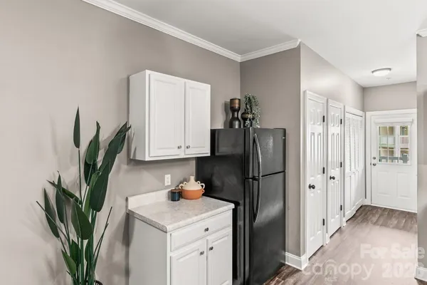 a kitchen with stainless steel appliances a refrigerator a sink a counter space and cabinets