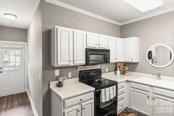 a kitchen with a sink stove top oven and cabinets