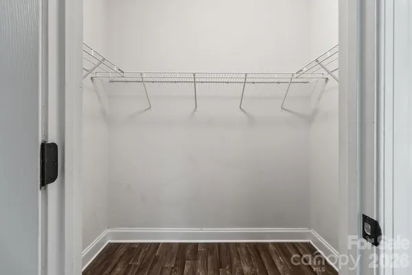 a view of walk in closet with empty racks