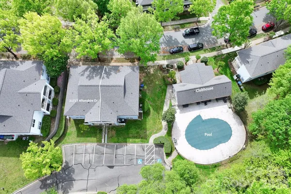 an aerial view of a house with garden space and street view