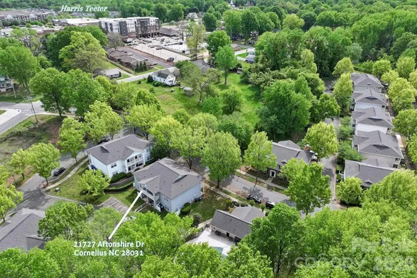 an aerial view of multiple houses with yard