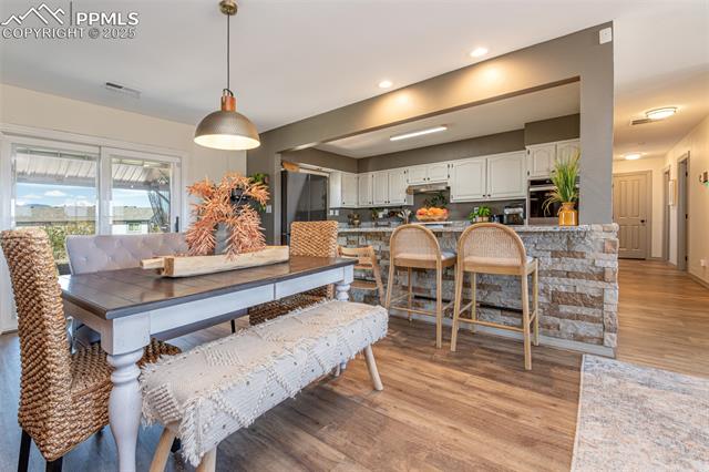 11170 Peaceful Valley Road Colorado Springs, CO 80925 - Photo 15 of 49 Dining space featuring light wood-style flooring and recessed lighting
