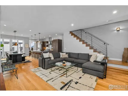 a living room with furniture and kitchen view