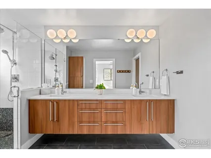 a bathroom with a sink vanity and a mirror