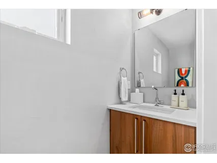 a bathroom with a sink vanity and a mirror