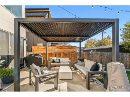 a balcony with table and chairs