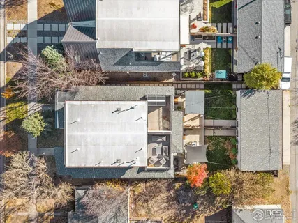 a view of a house with a backyard and a tree