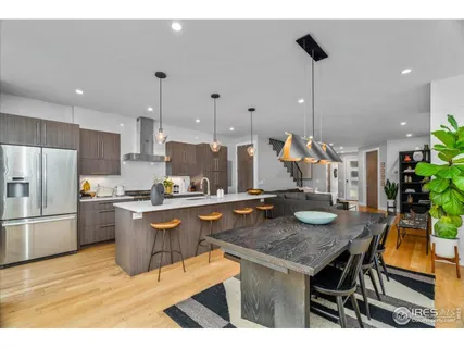 a kitchen with sink cabinets and wooden floor