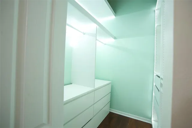 a bathroom with a sink a mirror a vanity and a shower