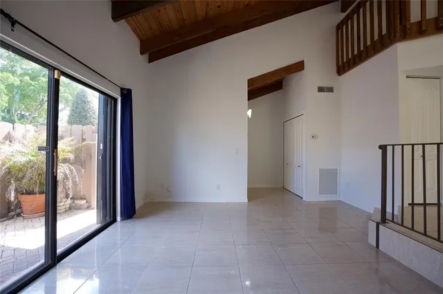 a view of empty room with floor to ceiling window