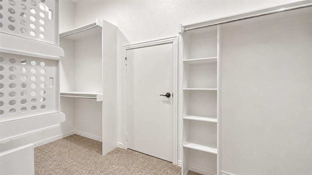 5216 Troupe Road McKinney, TX 75071 - Photo 23 of 40 Primary Bedroom Closet with door to understairs storage area. AI