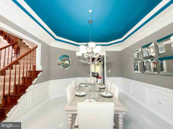 a living room with stainless steel appliances kitchen island granite countertop a refrigerator and a stove top oven