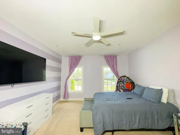a view of kids room with toys and wooden floor