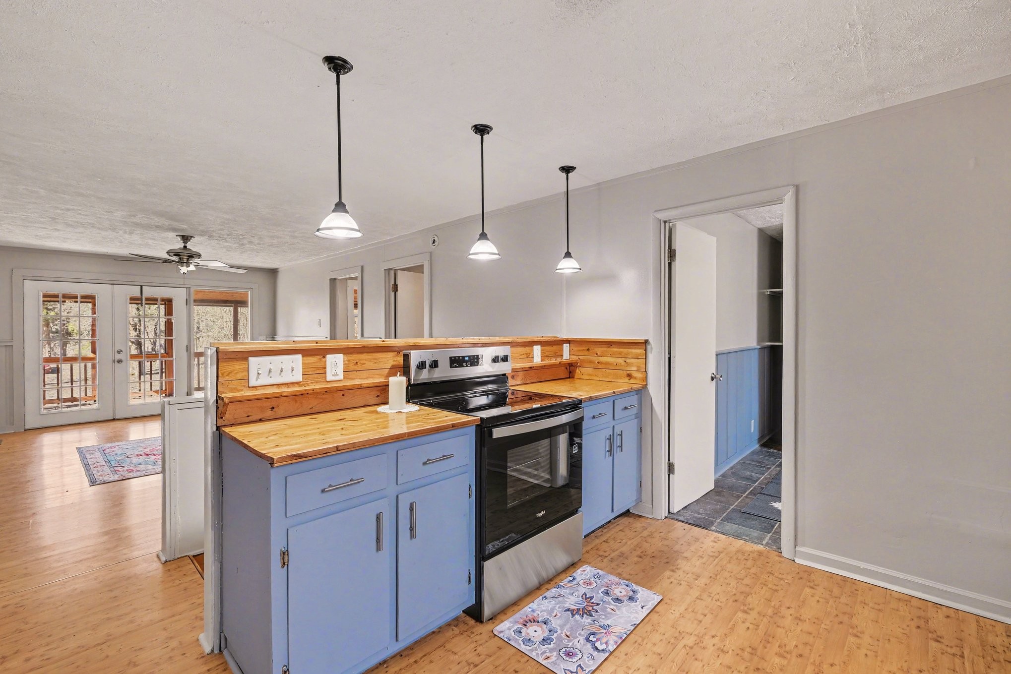 2650 Pretty Creek Road Nunnelly, TN 37137 - Photo 17 of 30 a kitchen with stainless steel appliances granite countertop a sink a stove and a wooden floors