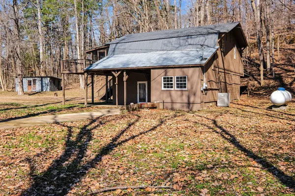 a view of a house with wooden fence