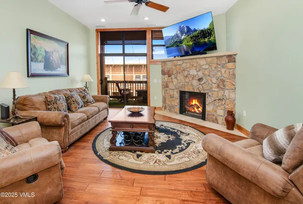 a living room with furniture and a fireplace