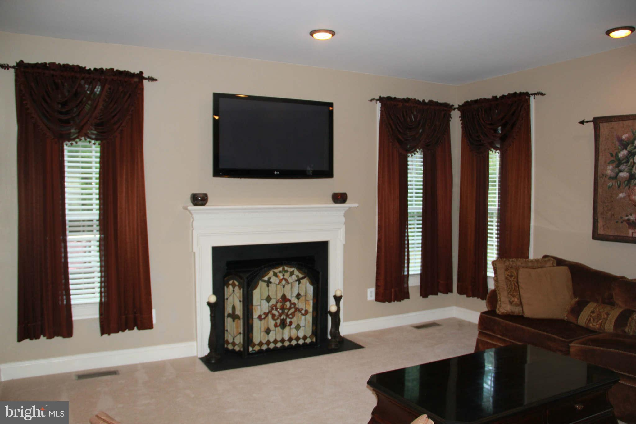 10809 Catron Road Perry Hall, MD 21128 - Photo 11 of 30 a living room with furniture a fireplace and a flat screen tv