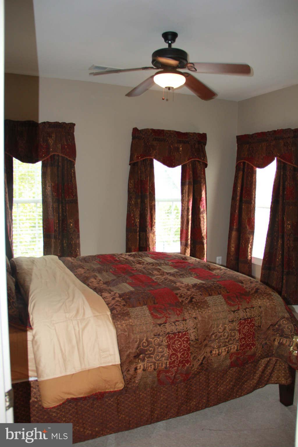 10809 Catron Road Perry Hall, MD 21128 - Photo 23 of 30 a bedroom with a large bed and a chandelier