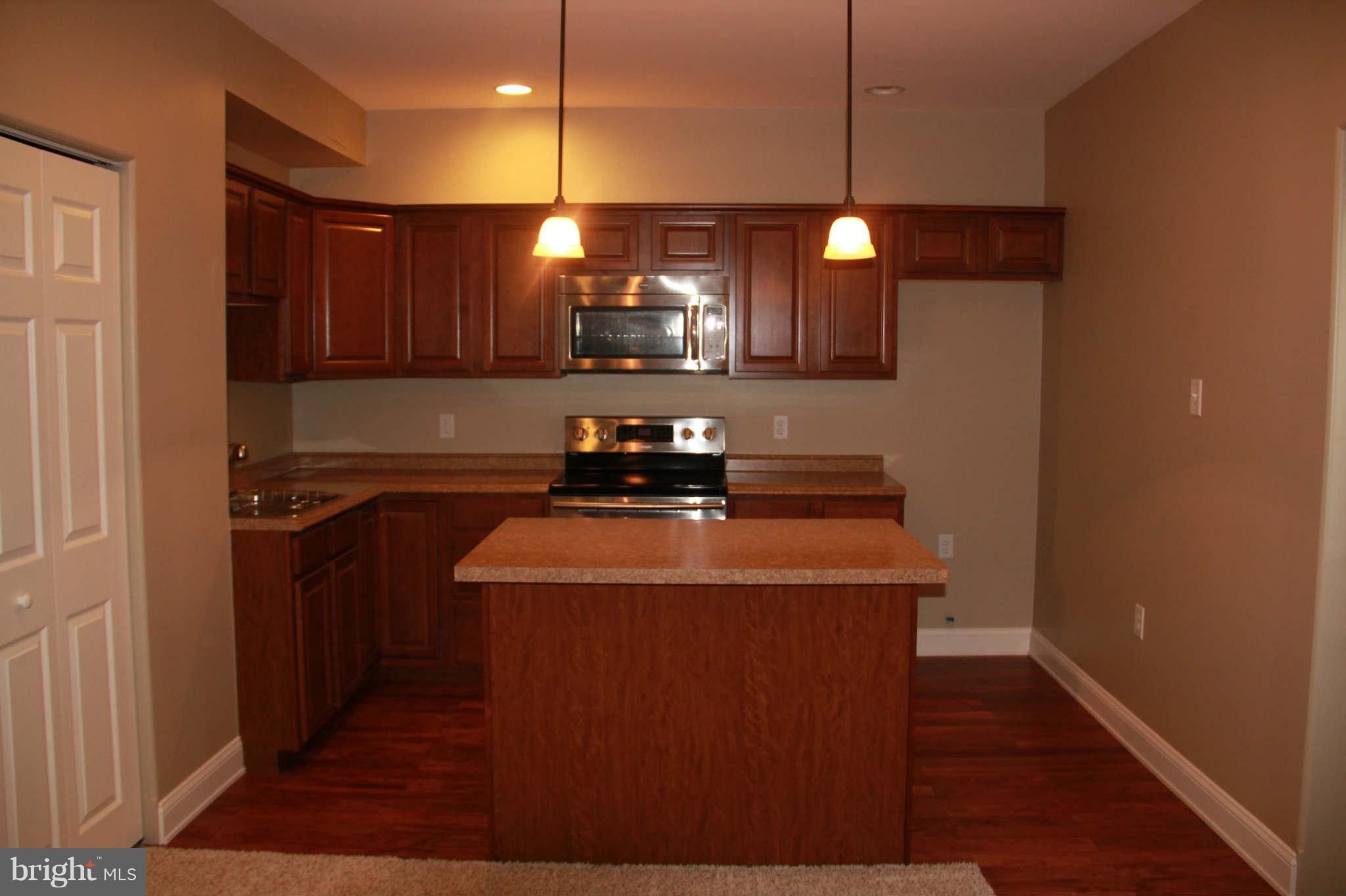10809 Catron Road Perry Hall, MD 21128 - Photo 27 of 30 a kitchen with a sink a refrigerator and chairs
