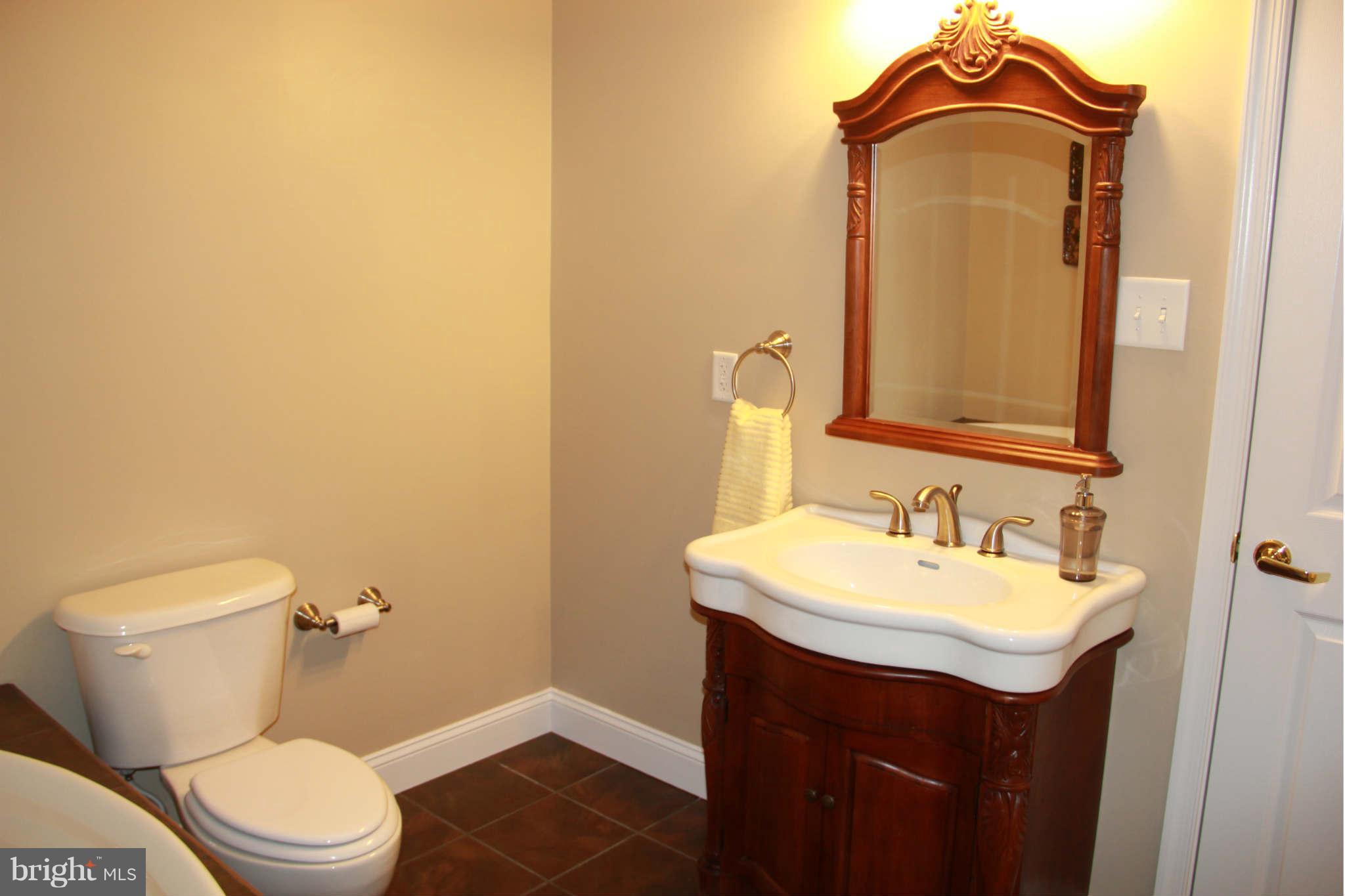 10809 Catron Road Perry Hall, MD 21128 - Photo 29 of 30 a bathroom with a sink a toilet and mirror