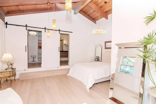 a bedroom with a bed window and a chair