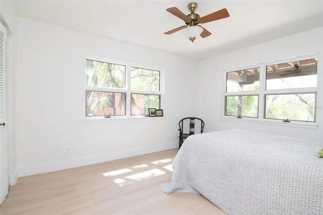 an aerial view of residential houses with outdoor space and trees
