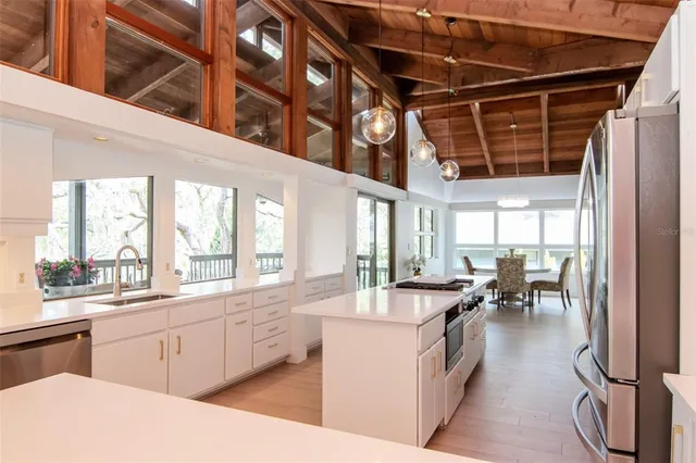 a bed sitting in a spacious bedroom next to a window